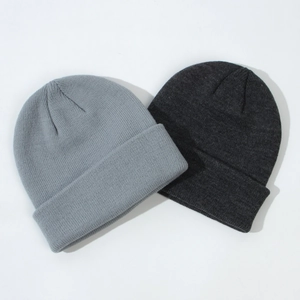 Close-up of ribbed knit texture on grey and charcoal children's beanies
