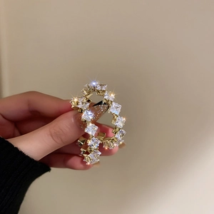 Pendientes dorados en forma de C con circonitas cuadradas sobre base de metal