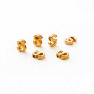 Close-up of golden letter S beads with 1.8mm hole for DIY jewelry making