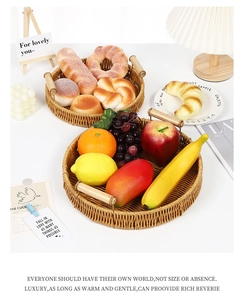 Top view of handwoven imitation rattan serving trays with wooden handles and bread