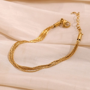 Detail of 18K gold plated multi-strand woven chain bracelet with lobster clasp
