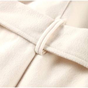 Detailed view of stitching and premium wool texture on a white V-neck coat