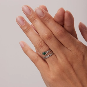 18K gold plated stainless steel snake ring with green zircon stone on a model's finger