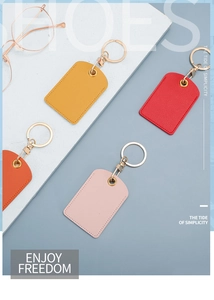 Flat lay of colorful PU leather keychains for access cards in yellow, red, orange and pink