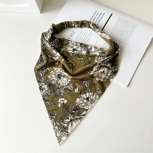 Detailed flat lay of olive green cotton floral headscarf with elastic band on white background