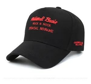 Detail of red embroidery text on large black five-panel baseball cap with curved brim