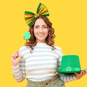 Green and gold glitter bow headband with a mini top hat for Saint Patrick's Day party
