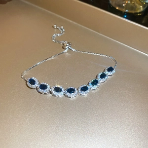Détail du bracelet réglable en argent avec pierres bleues ovales et sertissage de zircons
