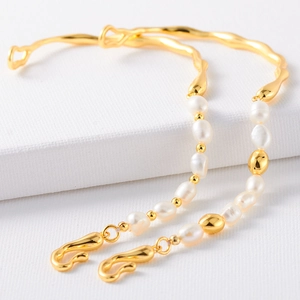 French style gold semi-bracelet with natural baroque pearls and elegant S-clasp design