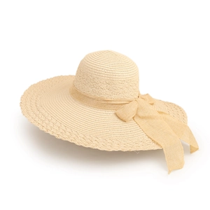 Detailed close-up of beige straw sun hat with elegant wide ribbon bow decoration