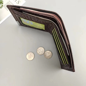 Detail view of brown crocodile texture wallet with multi-card slots and zipper compartment