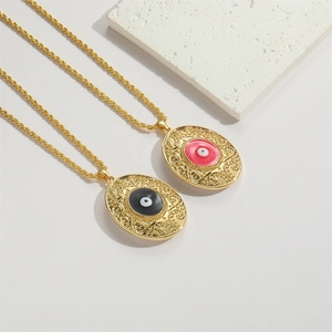 Detailed view of vintage oval evil eye pendants with red and black enamel on twisted gold chains