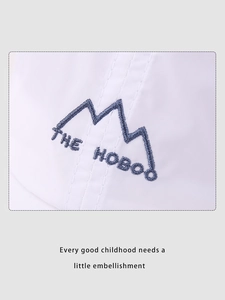Close-up of mountain embroidery and logo on breathable white quick-dry kids baseball cap