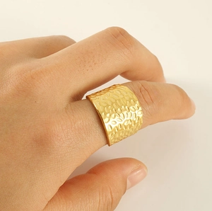 Detail of 18K gold-plated wide band ring with elegant hammered texture and matte finish
