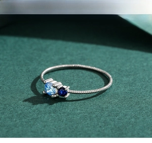 Detailed view of S925 silver ring with snake chain band and blue zircon stones