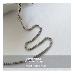 Detail view of silver snake chain strap with lobster clasp on acrylic star handbag