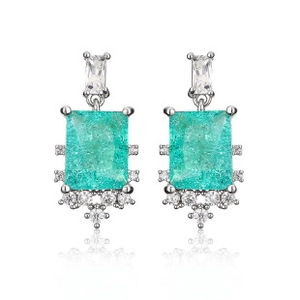 Detail macro view of pear-shaped mint green gemstone earrings with diamond halo