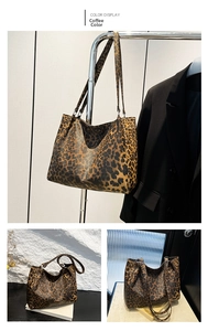 Detail of coffee leopard print tote bag styled with a blazer on a minimalist hanger