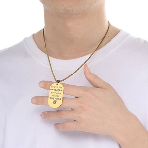 Detail shot of a gold stainless steel dog tag necklace with a meaningful message for dads