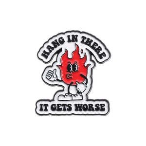 Cartoon red fire enamel pin with Hang In There text on a clean white background