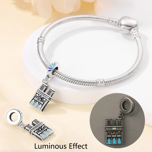 Detailed macro view of Notre Dame luminous charm showing daylight and glow-in-the-dark effects