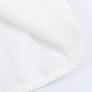 Close-up of white woven fabric texture with precise stitching and refined seam details