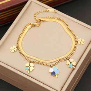 Detail of a double-layer stainless steel clover necklace with blue and white enamel