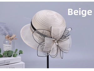 Detail of elegant beige organza hat with a large decorative bow and black trim accent