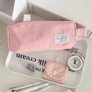 Pink quilted nylon pencil case with buckle strap and matching small coin pouch for students