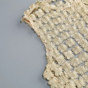 Close-up of golden floral embroidery on beige mesh fabric for women's two-piece set