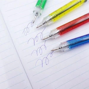 Set of four syringe-shaped ballpoint pens in colorful liquid styles on a notepad