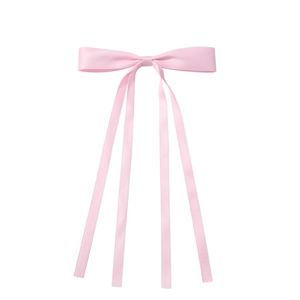 Detail of light pink satin bow hair clip with four long elegant flowing tassel ribbons