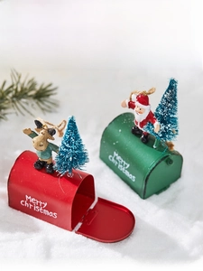 Detailed view of red and green Christmas mailbox ornaments with Santa and reindeer figurines