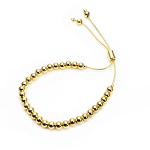 Detailed close-up of gold-plated beaded bracelet featuring adjustable slider and metal beads