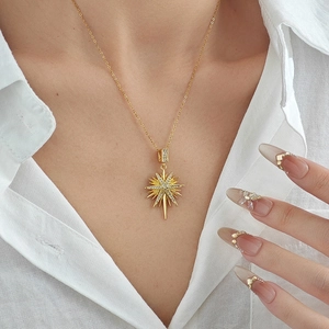 Elegant gold eight-point star pendant necklace with cubic zirconia on a thin link chain