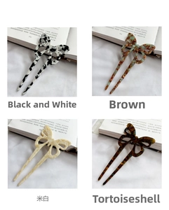 Detail showing acetate butterfly hair pins in marble, tortoise shell, and pearl finishes