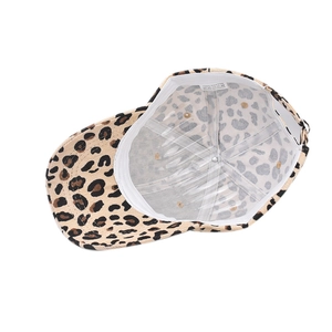 Detail view of leopard print baseball cap showing 100% cotton inner lining and tag