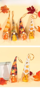Detailed close-up of autumn harvest gnome hanging ornaments with maple leaf and pumpkin hats