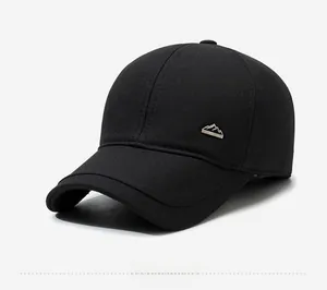 Detail view of winter baseball cap with ear flaps and silver mountain metal logo