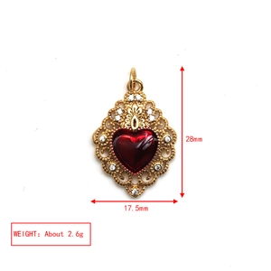 Detailed view of red heart pendant with gold filigree and dimensions 28mm by 17.5mm