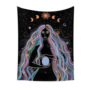Detail of bohemian tapestry featuring a mystical woman holding a starry blue sphere