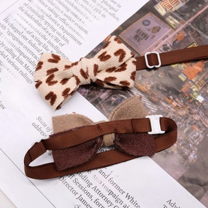 Detail view of leopard print corduroy and brown fabric pet bow ties with adjustable buckles