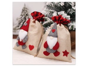 Detail view of burlap Christmas gnome gift bags with red and grey felt drawstring closures