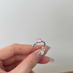 Detail of S925 silver ring featuring a pink heart stone and side pavé zircon accents