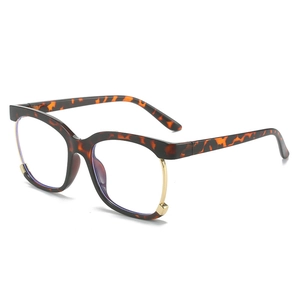 Fashionable tortoise shell square owl frame glasses with golden metal accents on white background