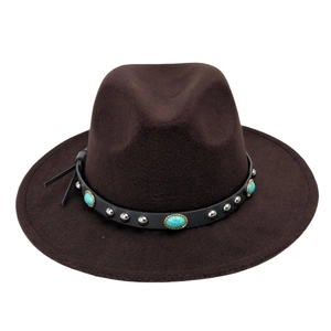 Close-up of leather band with turquoise stones and metal studs on a felt cowboy hat