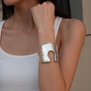 Detail of silver hammered texture cuff bracelet with irregular U-shaped cutout