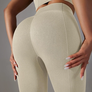 Detail of high-waisted yoga leggings featuring a honeycomb waffle texture in beige