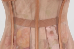 Detailed close-up of mesh fabric with floral print and premium leather edge piping