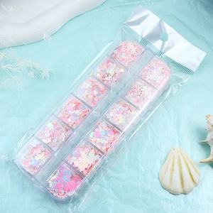 Detail of 12-grid organizer box with heart and butterfly glitter sequins for nail art